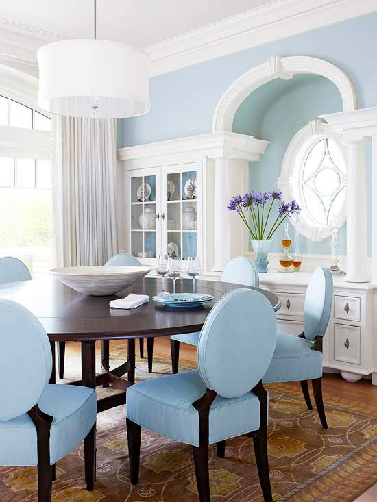 Elegant Light Blue Dining Room with Oval Chairs and Built-In Cabinetry