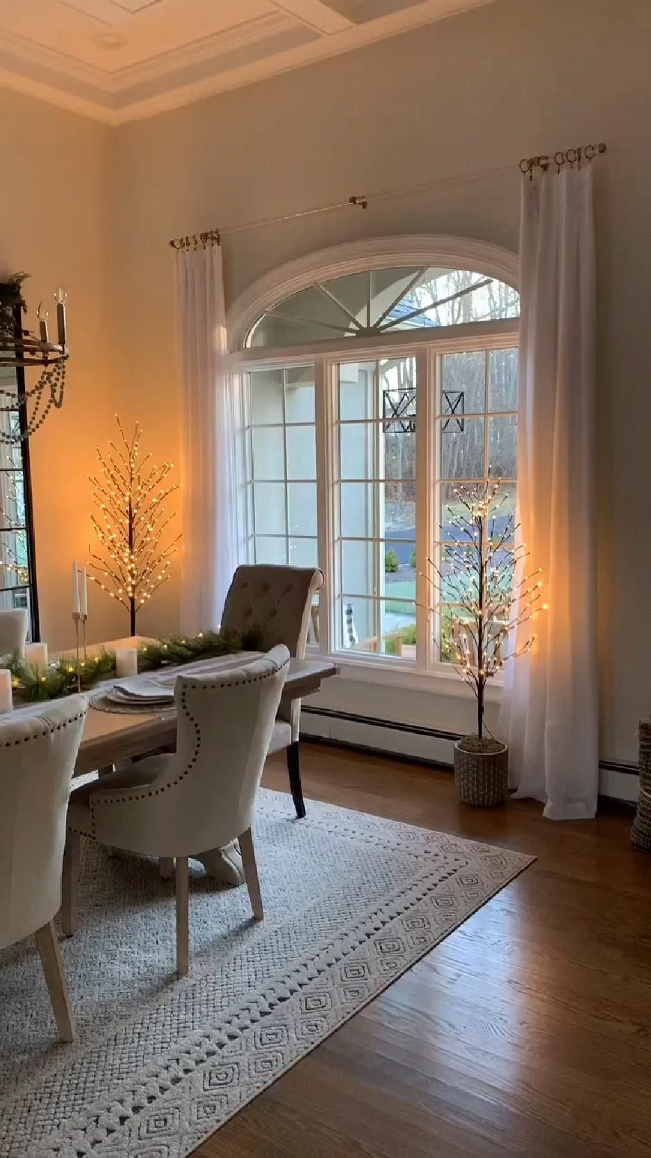 Elegant Dining Room with Large Arched Window and Soft Neutral Decor