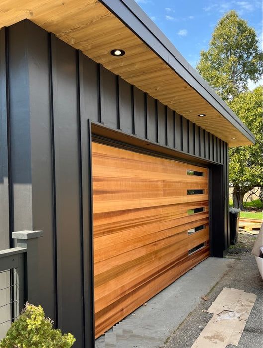 Modern Garage with Natural Wood Door and Black Siding
