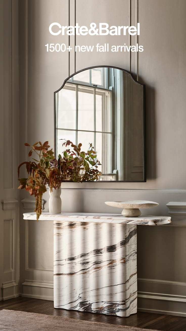 Modern Entryway With Fluted Marble Console and Arched Mirror