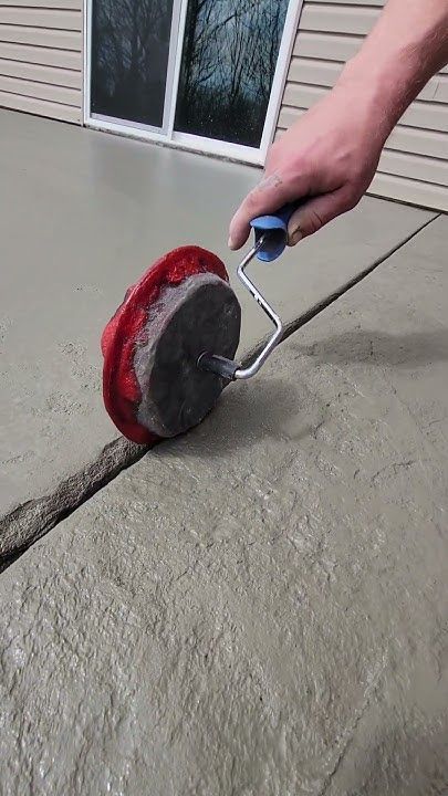 Creating a Control Joint in Fresh Concrete Patio with Roller Tool